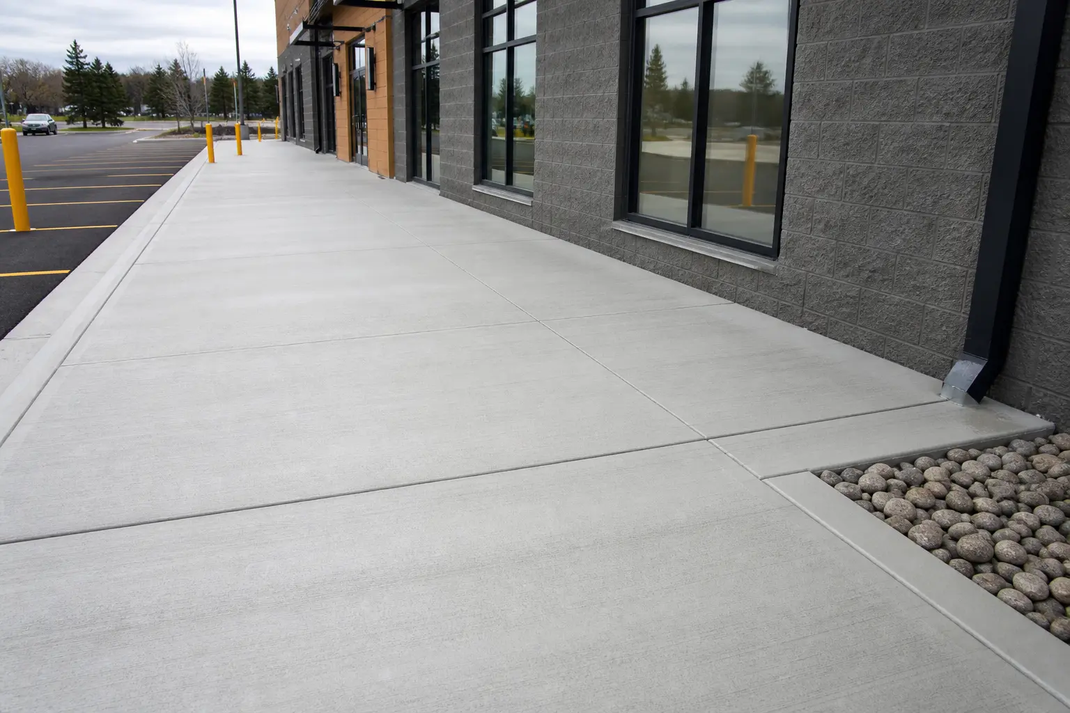 Clean commercial concrete sidewalk and foundation poured by Belmont Concrete Co.